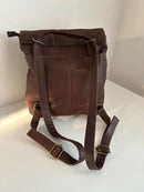 Brown Leather Backpack with Front Zip Pocket and Buckle Closure