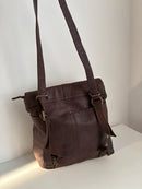 Brown Leather Backpack with Front Zip Pocket and Buckle Closure